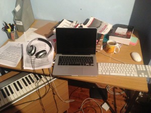 Picture of transcription services set up: computer, headphones, footpedal, keyabords.